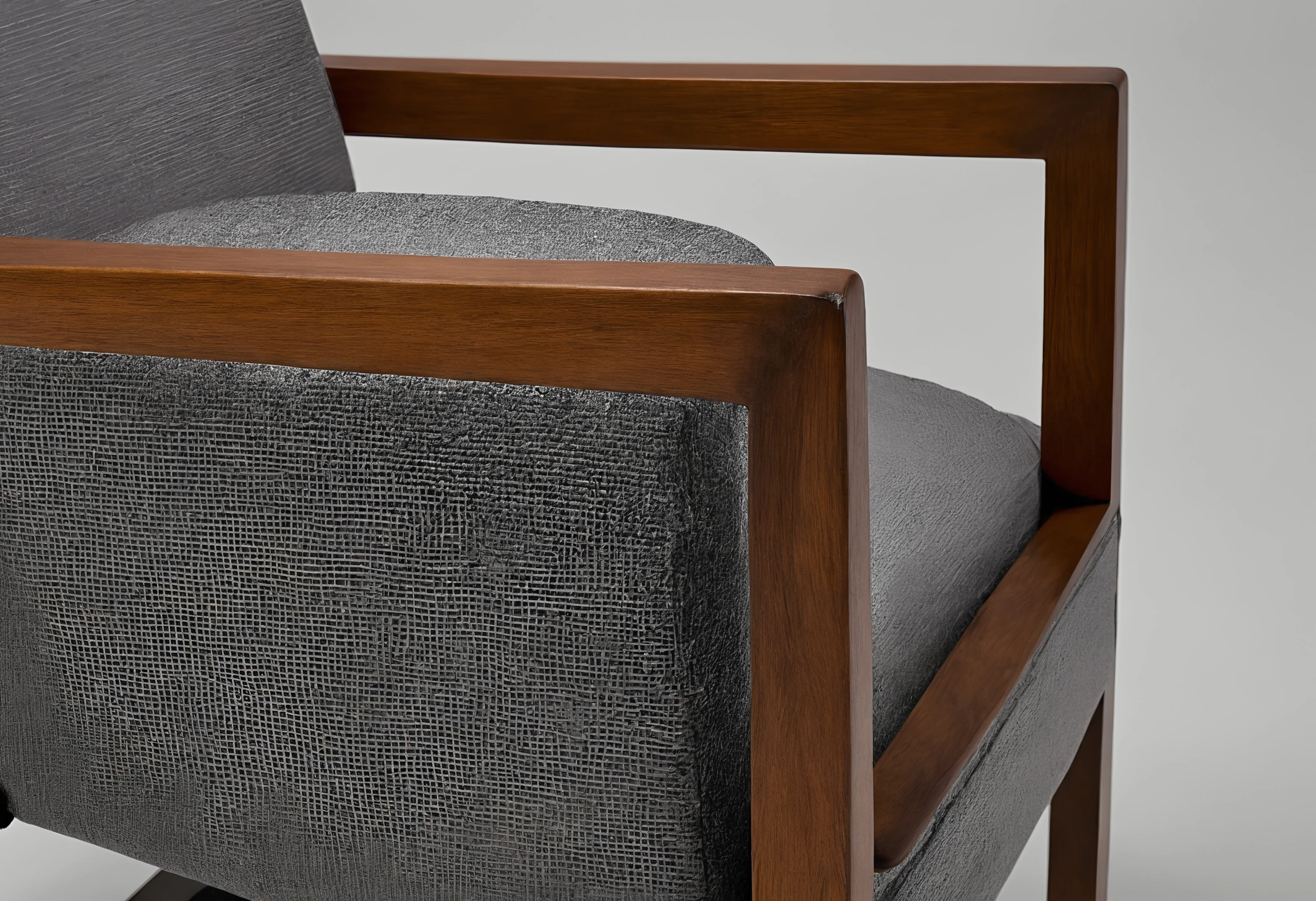 Underside of an upholstered chair showing frame construction, webbing, staples and a stamped identification plate area