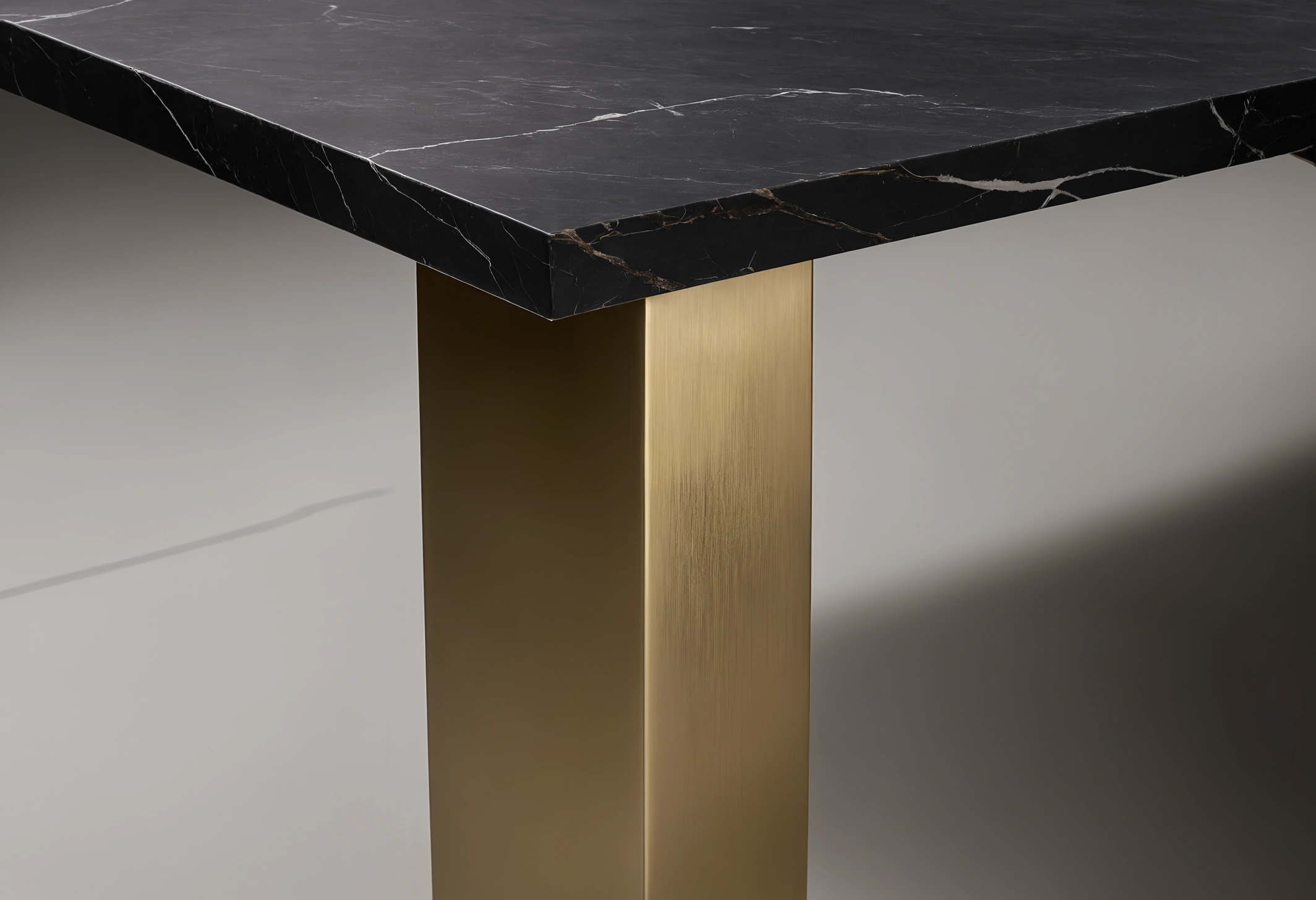 Close detail of a brushed brass furniture leg joint showing consistent finish into the corner and a clean weld