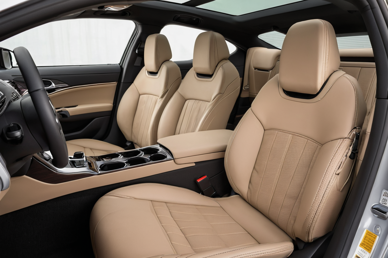 Tan upholstered seats and dark trim inside a car cabin