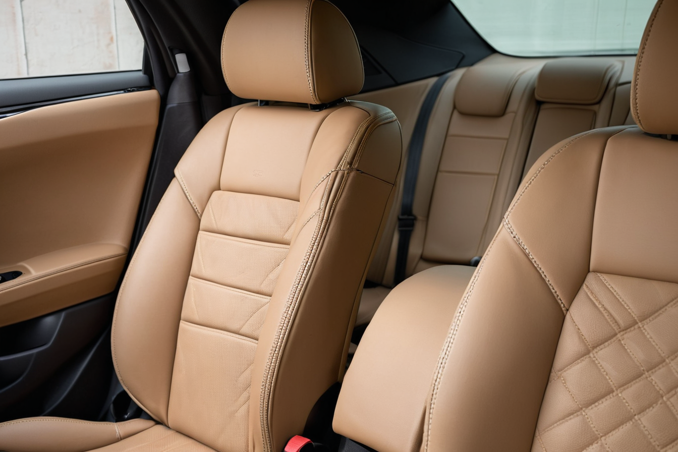 Close view of tan car-seat upholstery and stitching